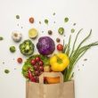 Top view of assortment of vegetables in paper bag