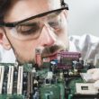 Male technician inserting chip in computer motherboard