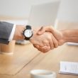 Closeup view of handshake, two businessmen in suits shaking hands