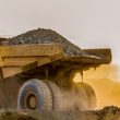 Large truck carrying sand on a platinum mining site