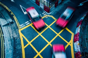 Cars driving through yellow no parking area