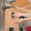 Hands in water at an outdoor tap