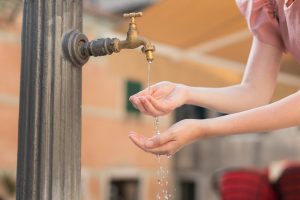 Hands in water at an outdoor tap