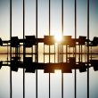 An office with a big chair and multiple chairs facing a sunset